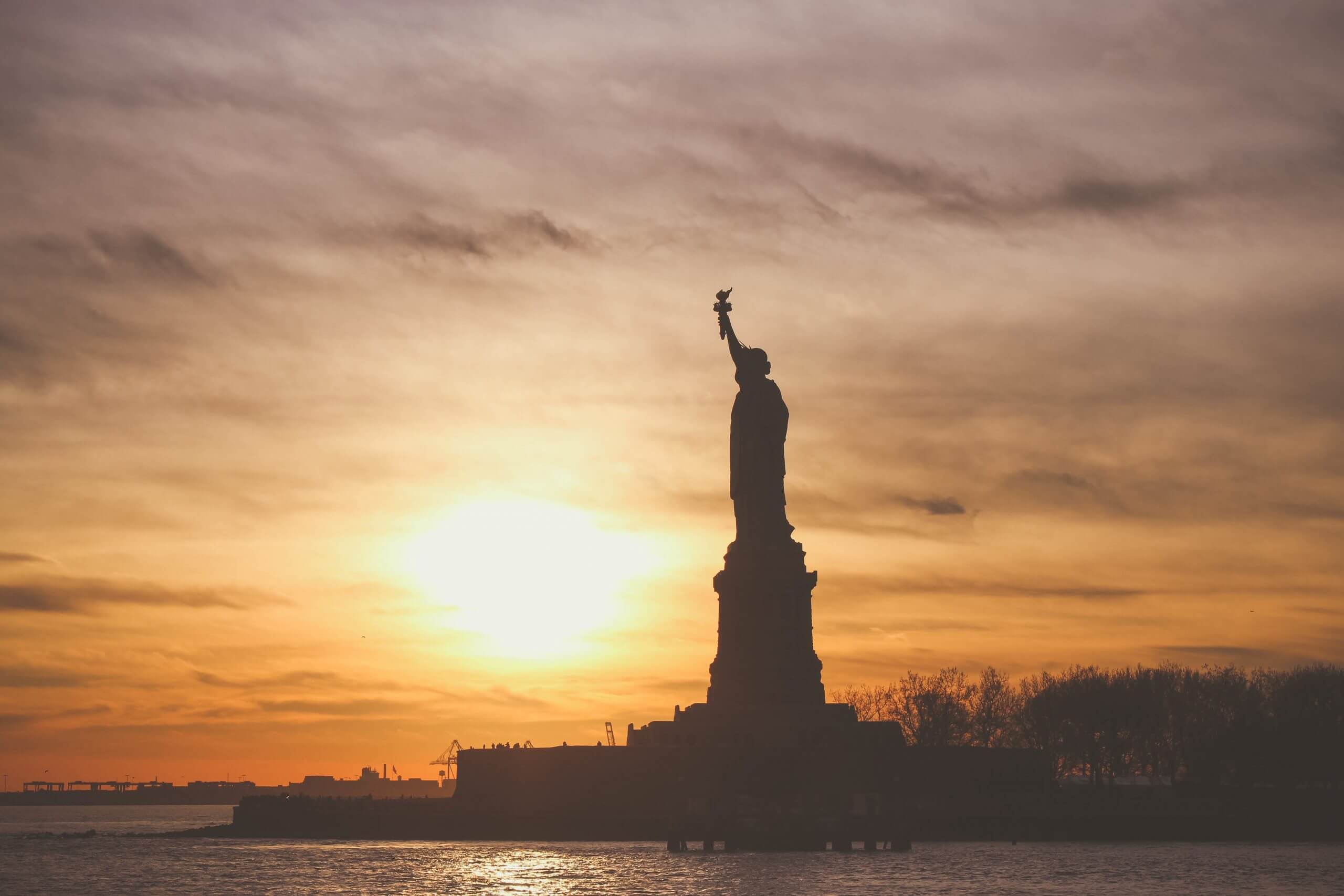 Canva - Silhouette of Statue of Liberty in a sunset